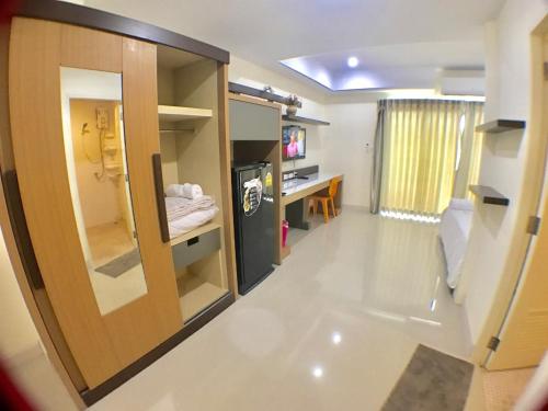 a room with a hallway with a door and a desk at AP Grand Residence in Rayong