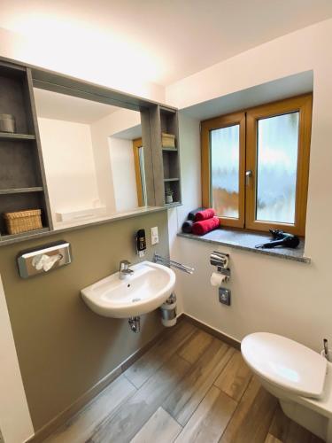 a bathroom with a sink and a mirror at Gästehaus Achental in Berchtesgaden