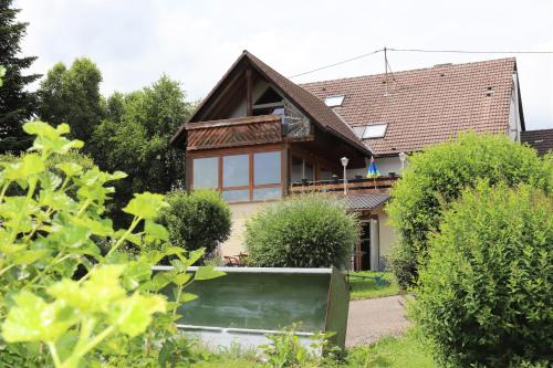 a house with a garden in front of it at Gästehaus Willaringen in Rickenbach