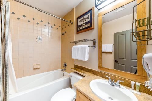 a bathroom with a tub and a sink and a toilet at Juniper Springs 444 in Mammoth Lakes