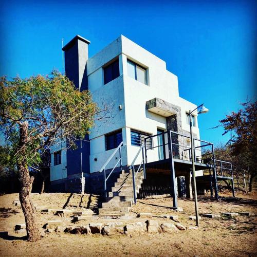 a building with a bunch of sheep in front of it at Complejo Megevand in Río Ceballos