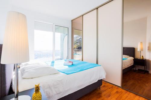 a bedroom with a bed and a large mirror at Terrace on the Bay 2 Villefranche-sur-Mer, AP4243 by Riviera Holiday Homes in Villefranche-sur-Mer