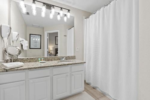 a bathroom with a sink and a shower curtain at Magic Holiday House in Orlando