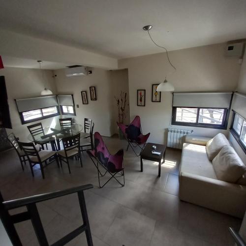 a living room with a couch and a table and chairs at Complejo Megevand in Río Ceballos