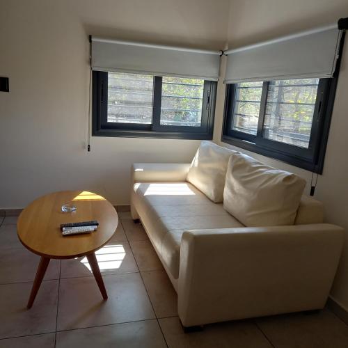 a living room with a white couch and a table at Complejo Megevand in Río Ceballos