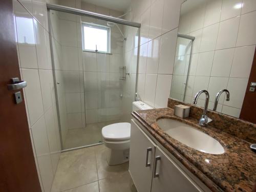 a bathroom with a sink and a toilet and a shower at Cobertura Duplex Algodoal in Cabo Frio