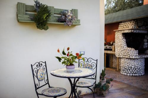 a table and two chairs and a table with flowers on it at A CASA DI SARA in Tivoli