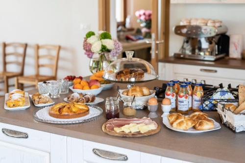 a table with various pastries and other foods on it at Agriturismo Bressani in Nimis