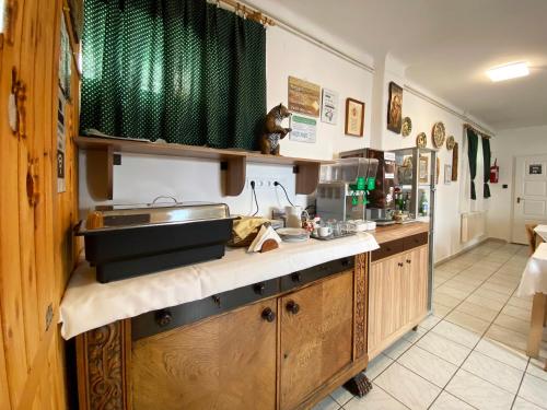 a kitchen with a sink and a counter top at Hargita Panzio in Vecsés