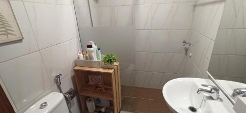 a bathroom with a sink and a toilet and a shower at Near Airport Comfy Stay Gran Canaria in Playa del Burrero