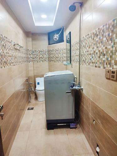 a bathroom with a toilet and a shower in it at 7K Heights in Murree
