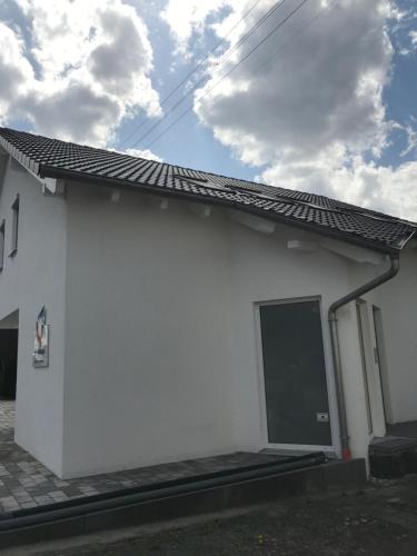a white house with a black door and a sky at Jeannette in Balingen