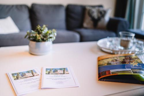 a table with two pamphlets on top of a table at A La Maison d'Ode in Sainte-Ode