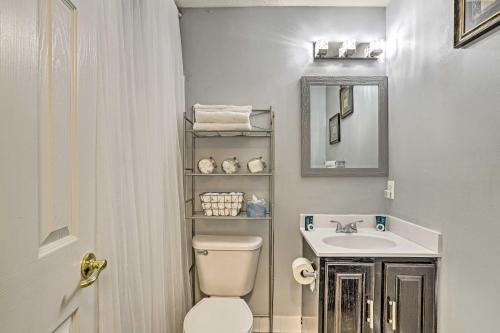 a bathroom with a sink and a toilet and a mirror at 32 Mi to DC Lower-Level Woodbridge Apt with Patio! in Woodbridge