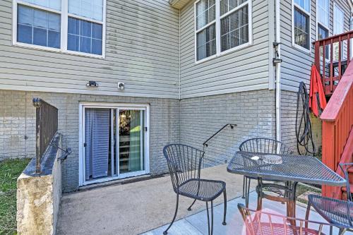 a patio with a table and chairs in front of a house at 32 Mi to DC Lower-Level Woodbridge Apt with Patio! in Woodbridge