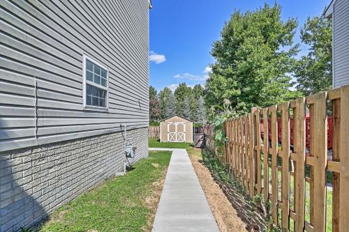 a walkway next to a fence next to a building at 32 Mi to DC Lower-Level Woodbridge Apt with Patio! in Woodbridge