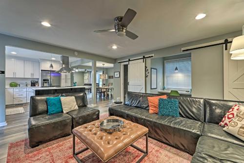 a living room with a leather couch and a table at Quiet Nashville Area Home with Pool - 15 Mi to Dtwn in Joelton