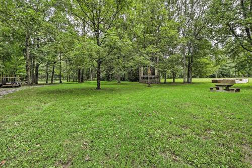 a park with benches and a picnic table and trees at Quiet Nashville Area Home with Pool - 15 Mi to Dtwn in Joelton