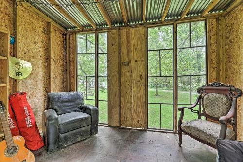 an empty room with a chair and windows at Quiet Nashville Area Home with Pool - 15 Mi to Dtwn in Joelton