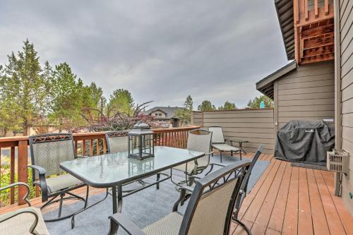 a patio with a table and chairs on a deck at Charming Redmond Townhome with Resort Amenities in Redmond