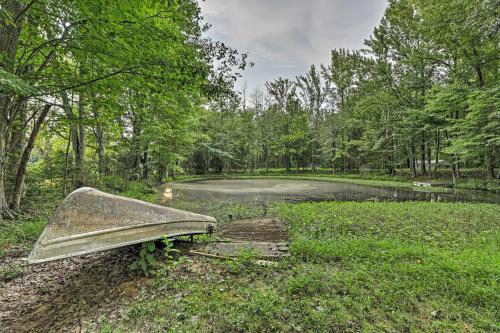 a boat sitting in the grass next to a river at Quiet Nashville Area Home with Pool - 15 Mi to Dtwn in Joelton