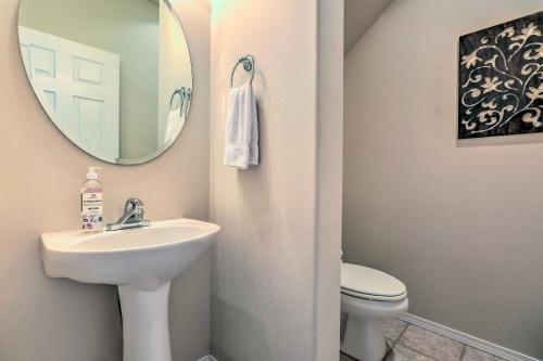 a bathroom with a sink and a mirror and a toilet at Charming Redmond Townhome with Resort Amenities in Redmond