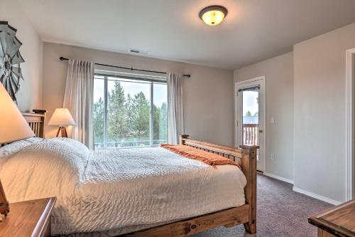 a bedroom with a bed and a large window at Charming Redmond Townhome with Resort Amenities in Redmond