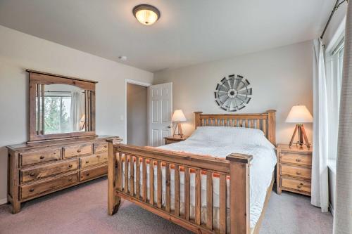a bedroom with a bed and a dresser and a mirror at Charming Redmond Townhome with Resort Amenities in Redmond