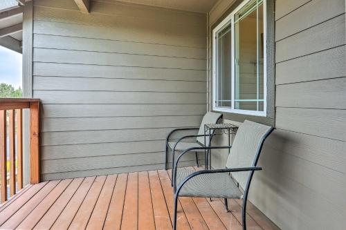 a porch with two chairs and a table on it at Charming Redmond Townhome with Resort Amenities in Redmond