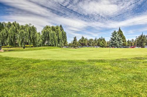 a golf course with a green field and trees at Charming Redmond Townhome with Resort Amenities in Redmond