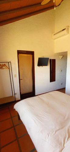 a bedroom with a white bed and a window at Pino Dorado in Punta del Este