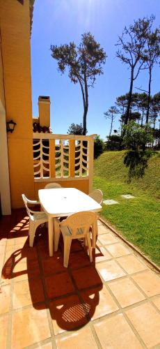 a white table and two chairs on a patio at Pino Dorado in Punta del Este