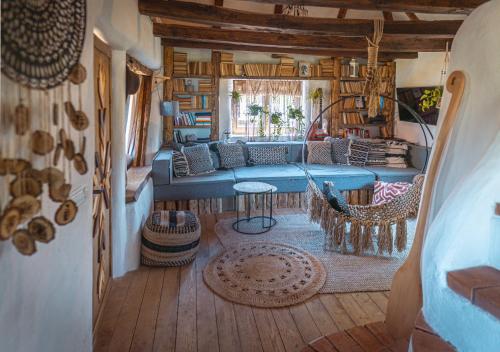 a living room with a couch and a table at Nooks by AdyBeca - Balnaca Traditional Nook in Bălnaca