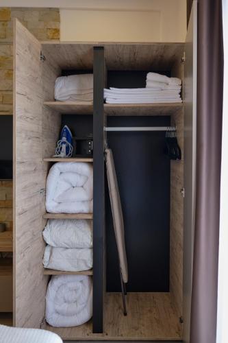 a walk in closet with towels in a room at L&N Apartmani Kopaonik-Milmari Resort in Kopaonik
