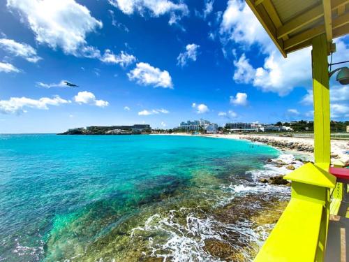 a view of the beach on a sunny day at Aquamarine, private room in Villa Casa Blue pool sea view in Koolbaai