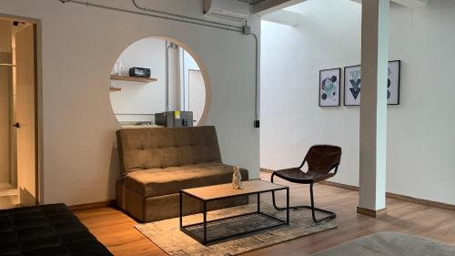 a living room with a couch and a table at Soy Local Primavera in Medellín
