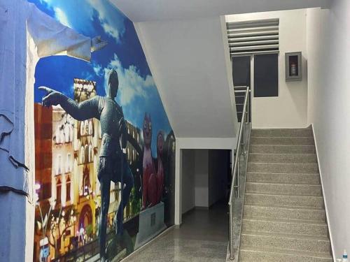 a hallway with a mural of a man on the wall at 304A-APARTA ESTUDIO DUPLEX MINI EN Granada in Cali