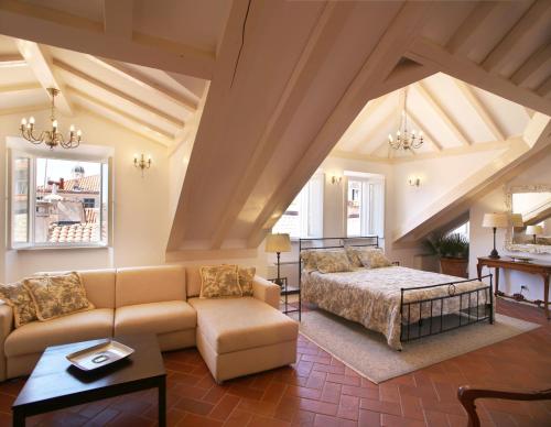 a living room with a bed and a couch at LOCUS Dubrovnik in Dubrovnik