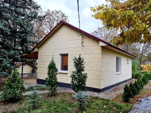 a small house with trees in front of it at Котедж бiля рiчки село Кудашiвка in Kudashevka