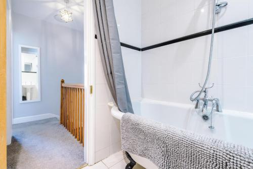 a bathroom with a shower and a bath tub at Fisherman's Cottage in Chester