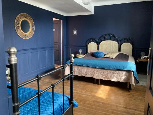 1 dormitorio con 1 cama con paredes azules en Les Rêveries, en Chazé-sur-Argos