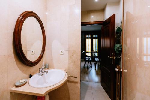 a bathroom with a sink and a mirror on the wall at Capricho de Vidania in Huesca