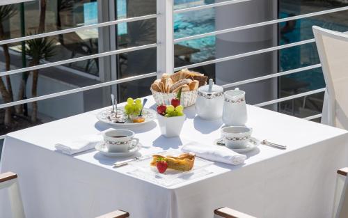a table with breakfast foods and cups on it at Hotel Terme Delle Nazioni in Montegrotto Terme