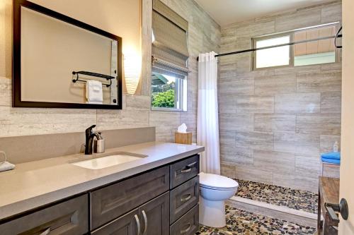 a bathroom with a sink and a toilet at Mahana House Country Inn in North Hilo