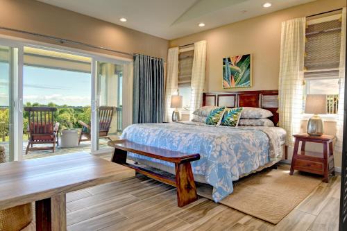 a bedroom with a bed and a sliding glass door at Mahana House Country Inn in North Hilo