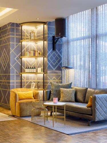 a living room with a couch and a table at Postboutique Hotel Wuppertal in Wuppertal