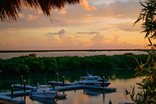a group of boats docked at a dock on a lake at Villas Grand Marina Kinuh in Telchac Puerto