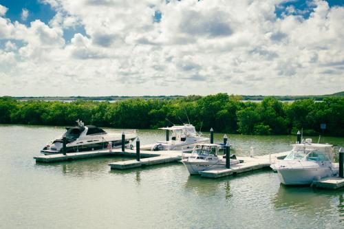 three boats docked at a dock in the water at Villas Grand Marina Kinuh in Telchac Puerto