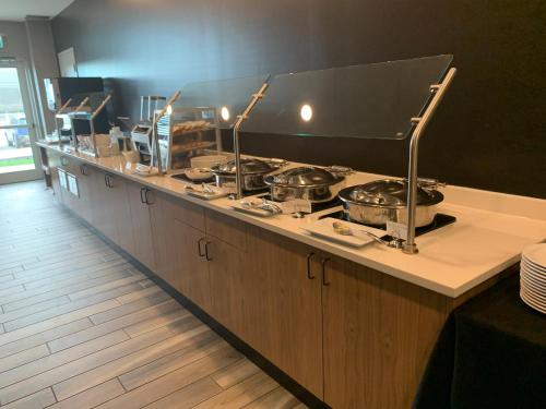 a counter with four pots and pans on it at Holiday Inn Hotel & Suites - Calgary Airport North, an IHG Hotel in Calgary