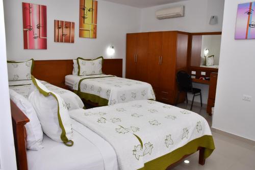 Кровать или кровати в номере Hotel B`Quin Plaza Cúcuta